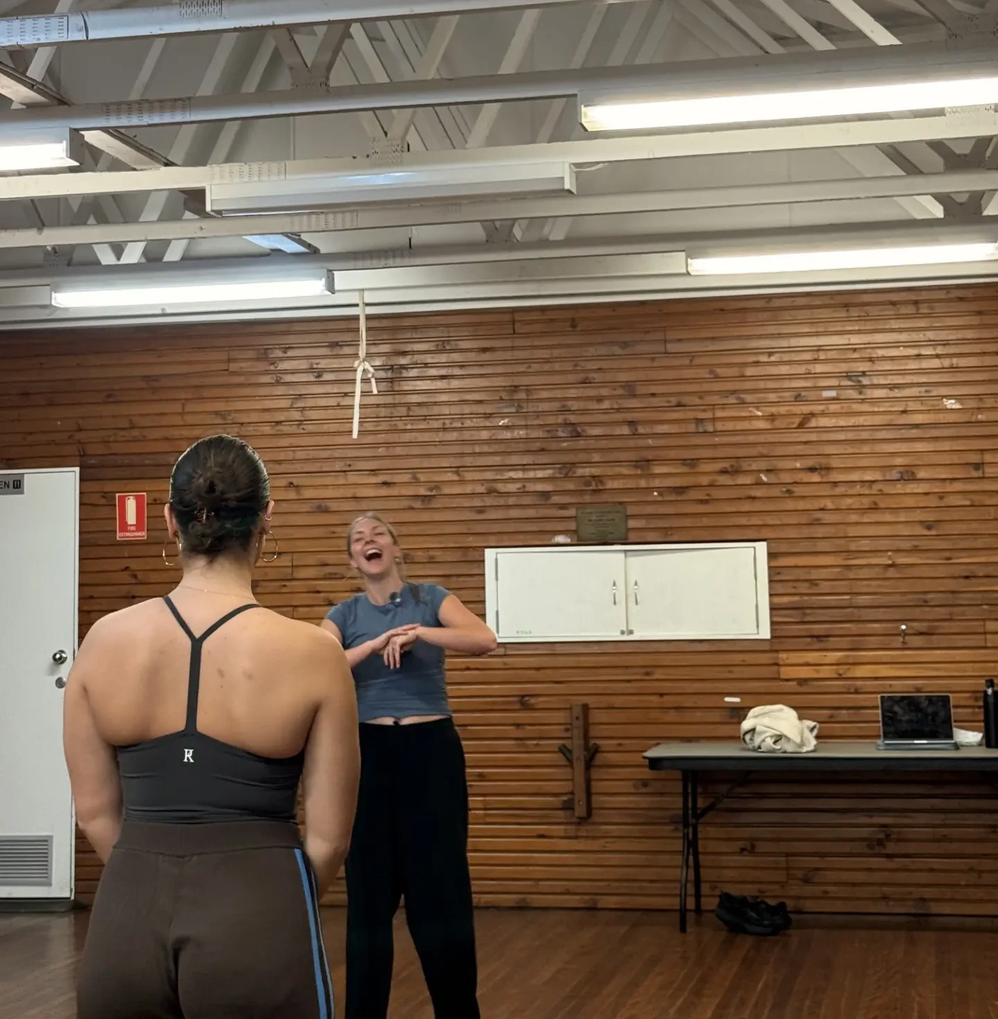 Two dancers laughing together during a NoCo class